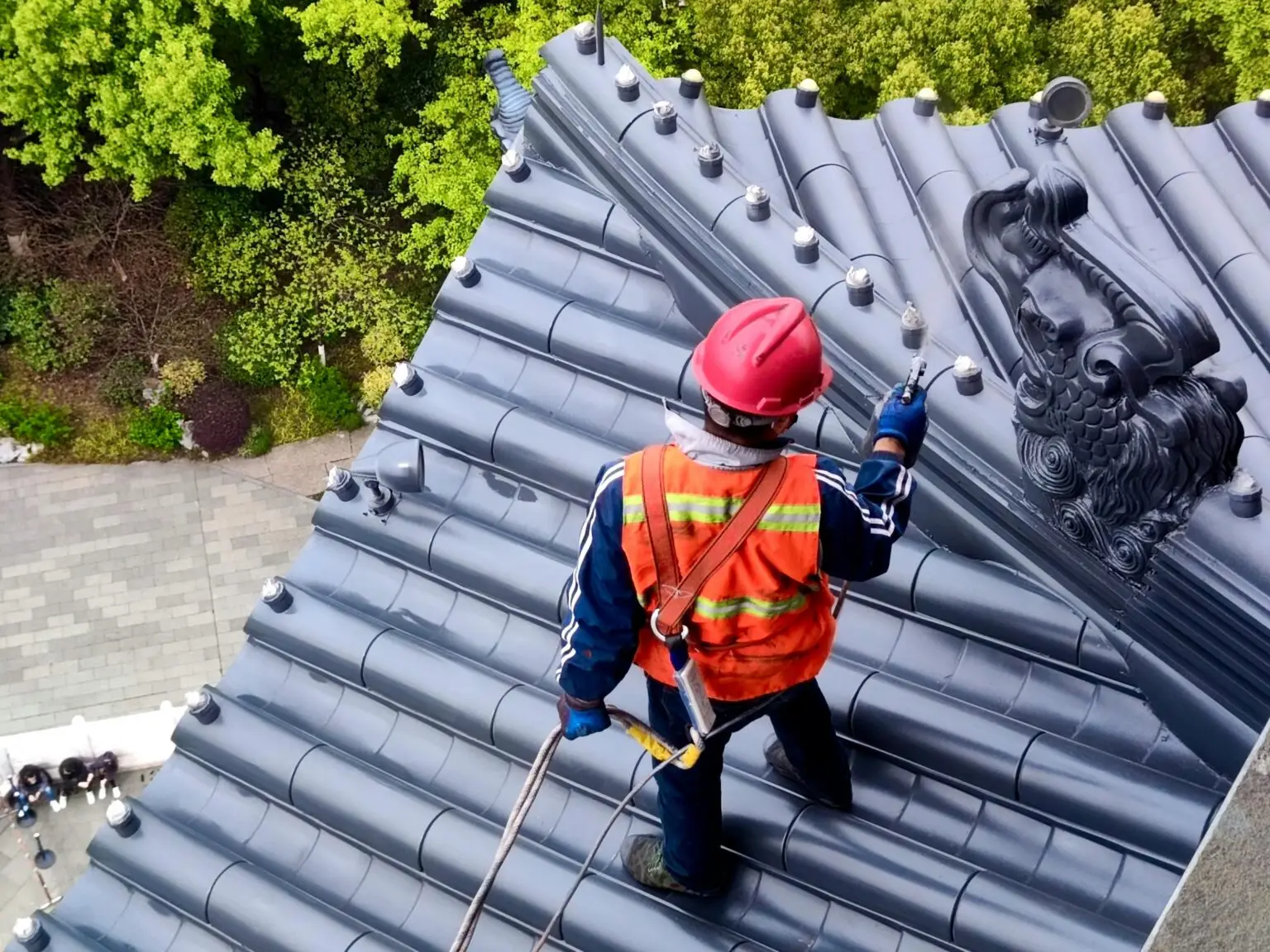 Roofer installing metal tile roofing on residential home — how we build roofer websites