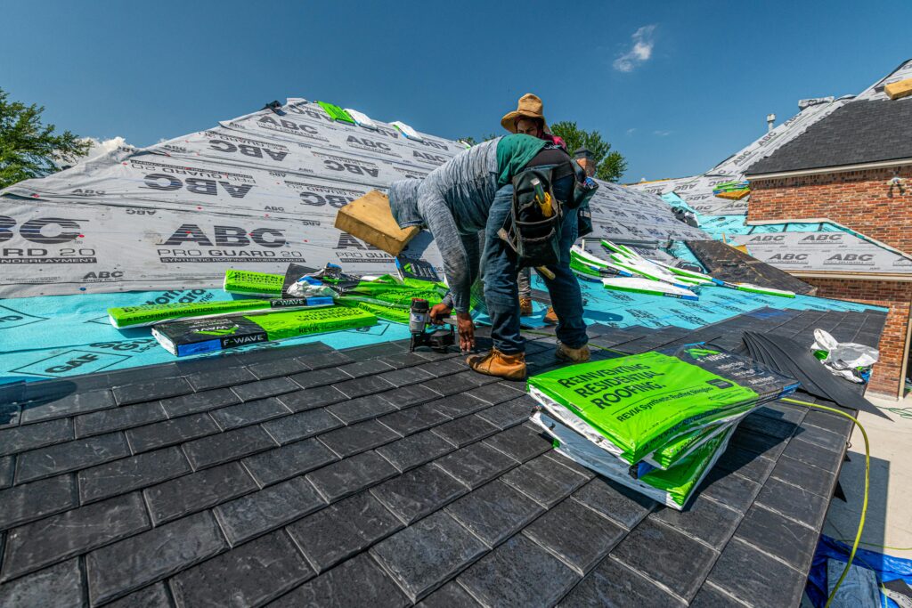 Roofer installing asphalt shingles on residential roof — roofer website design by Journela